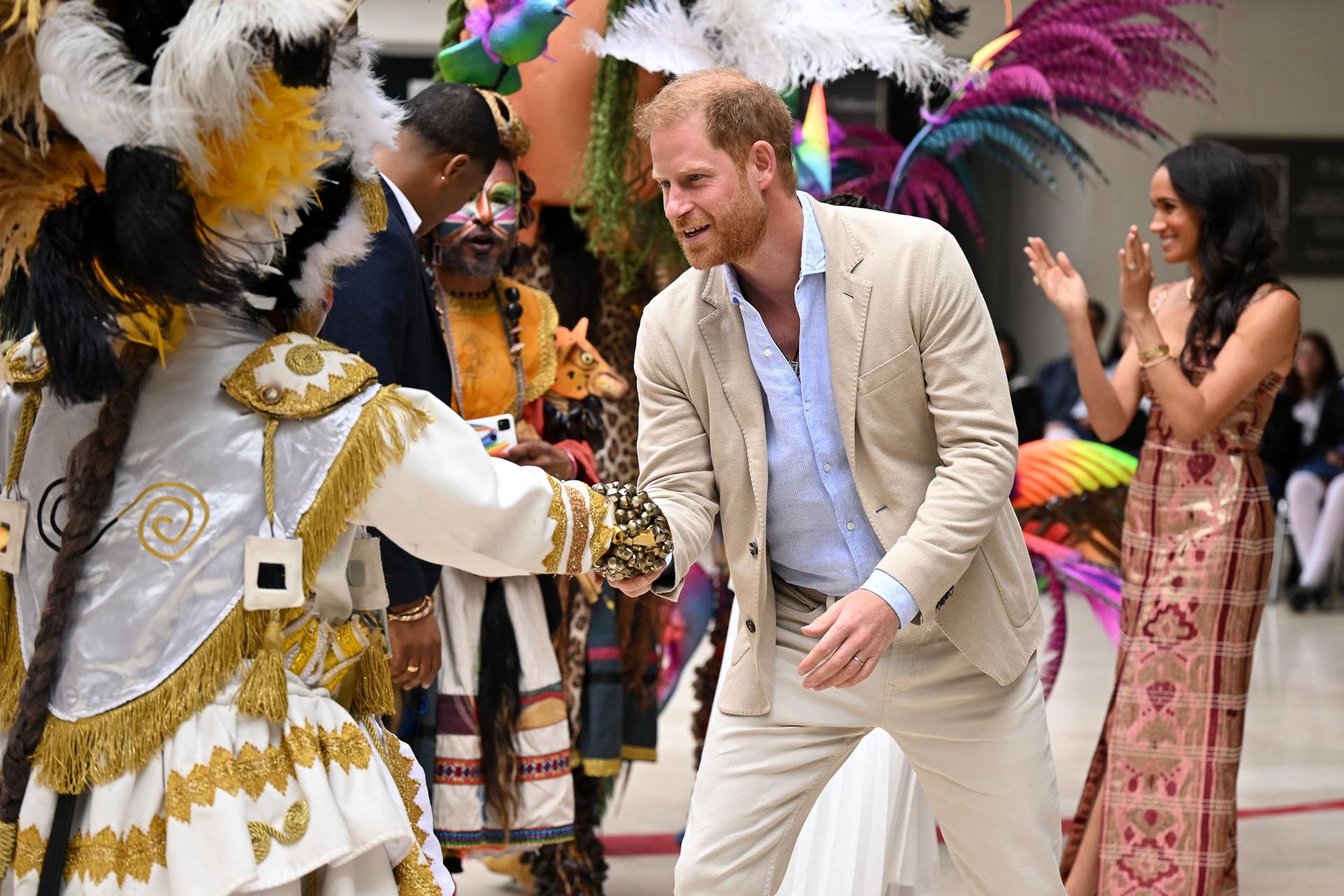 Prince Harry, the Duke of Sussex, greets an artist, next to his wife Meghan during a visit to the National Centre for the Arts in Bogota, Colombia on August 15, 2024