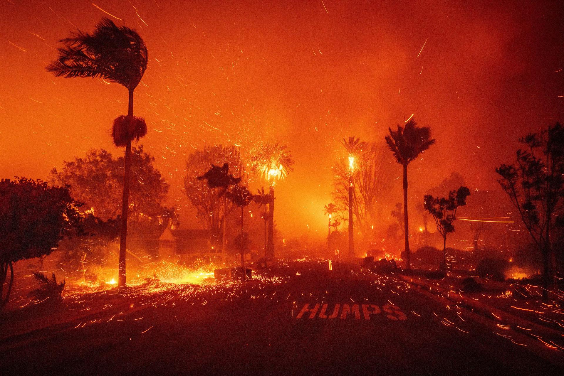 A fire ravages a neighborhood amid high winds in the Pacific Palisades neighborhood of Los Angeles on Tuesday.