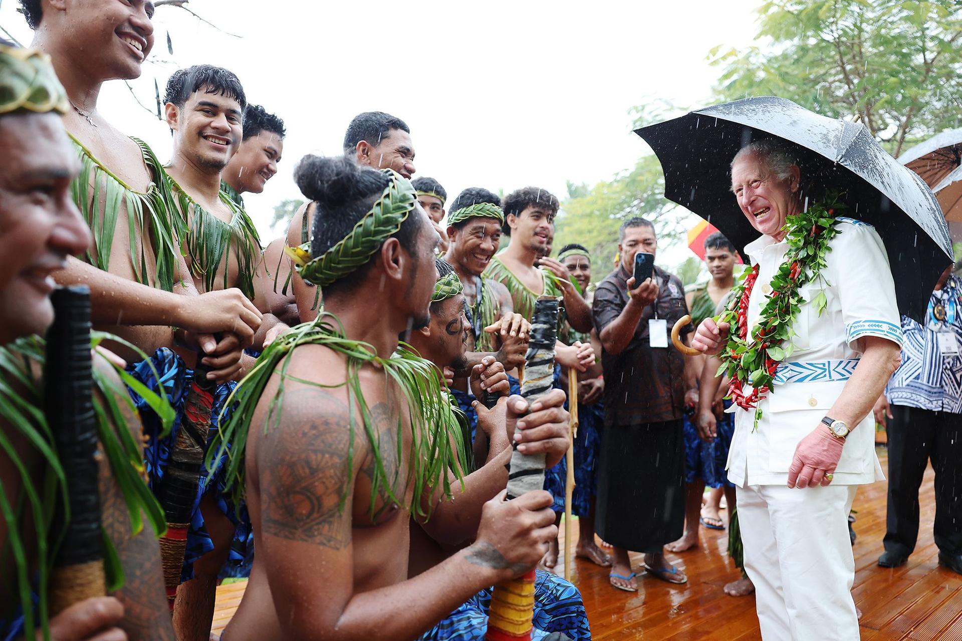 Charles cracks jokes as he meets a local traditional cricket team while at the Samoa Cultural Village on Thursday. 