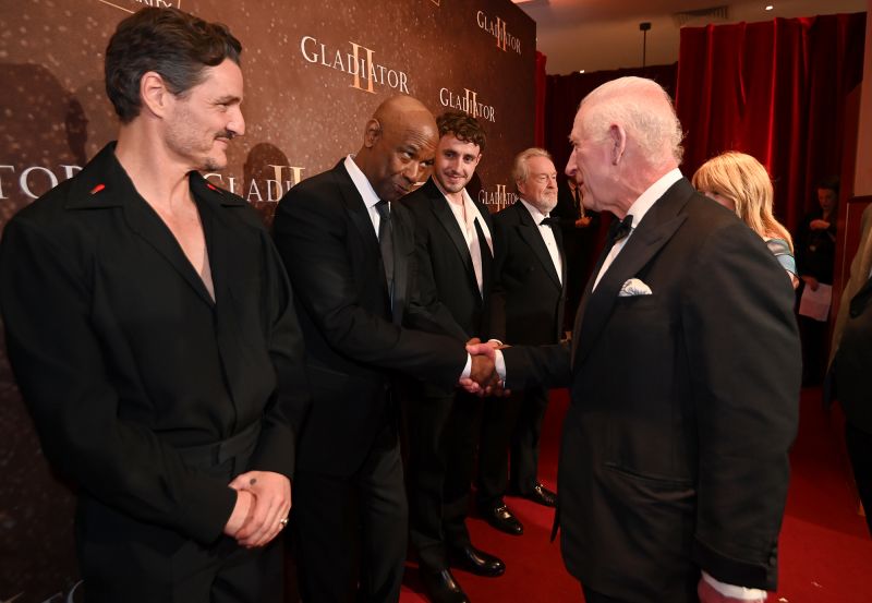 King Charles shakes hands with Denzel Washington at the global premiere of ''Gladiator II'' in London on Wednesday evening, as Pedro Pascal and Paul Mescal look on.